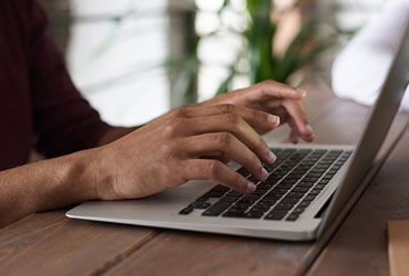 Courses person using macbook.jpg